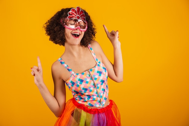 Beautiful Brazilian woman dressed in carnival clothes dancing