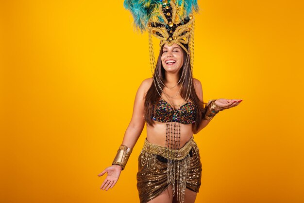 Beautiful Brazilian woman in golden carnival clothes wearing carnival dancer feather crown Welcome with open arms