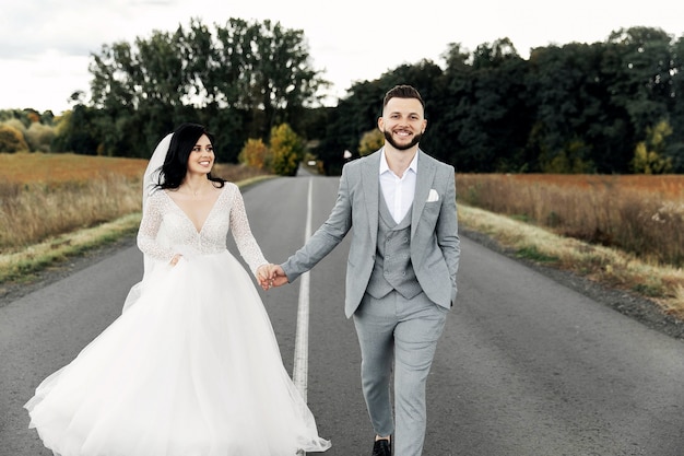 Beautiful bridal couple at sunset on the street