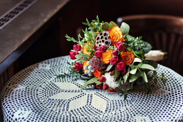 Beautiful bridal wedding bouquet lying on table