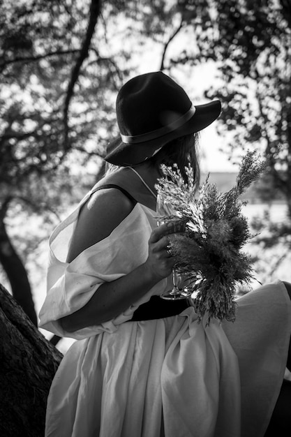 Beautiful bride in black hat with dried flowers