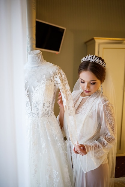 Beautiful bride dresses her white wedding dress