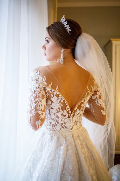 Beautiful bride dresses her white wedding dress