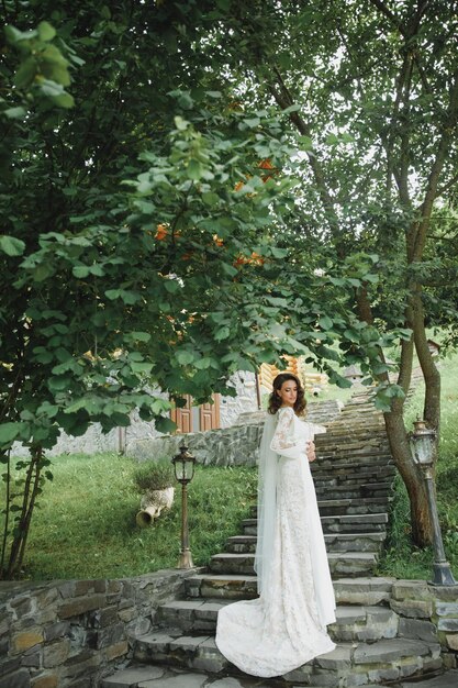 Beautiful bride in fashion wedding dress on natural background.