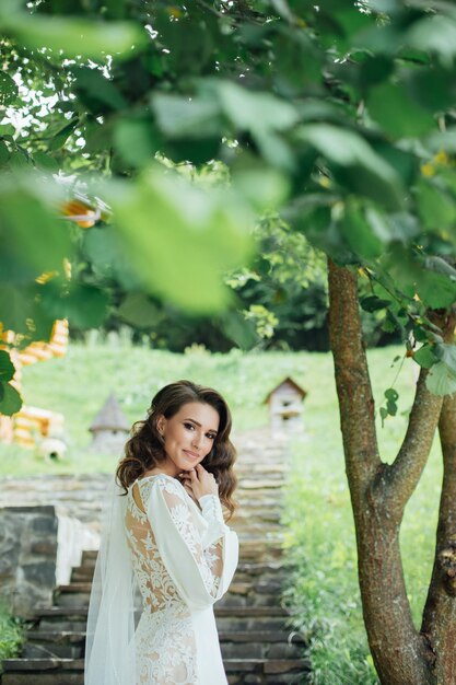 Beautiful bride in fashion wedding dress on natural background