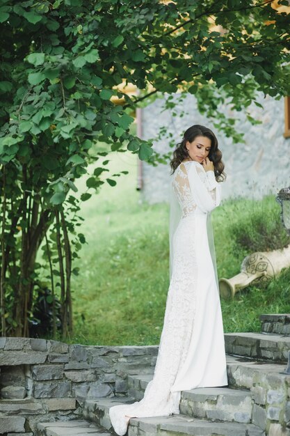 Beautiful bride in fashion wedding dress on natural background.