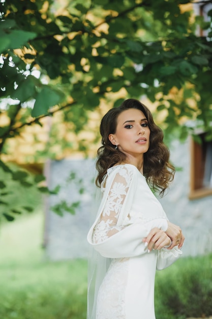 Beautiful bride in fashion wedding dress on natural background.