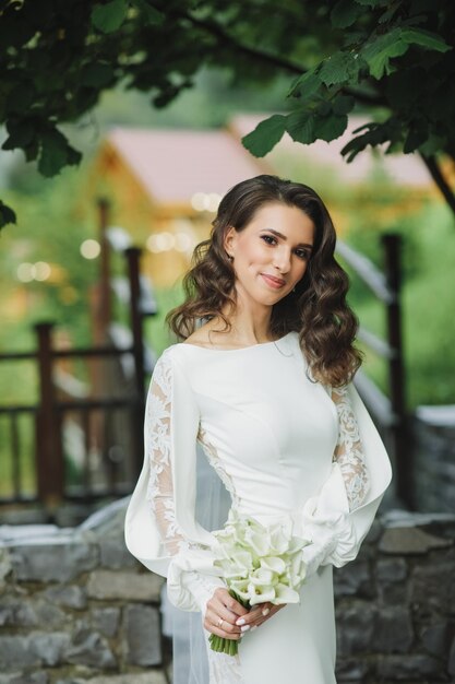 Beautiful bride in fashion wedding dress on natural background.