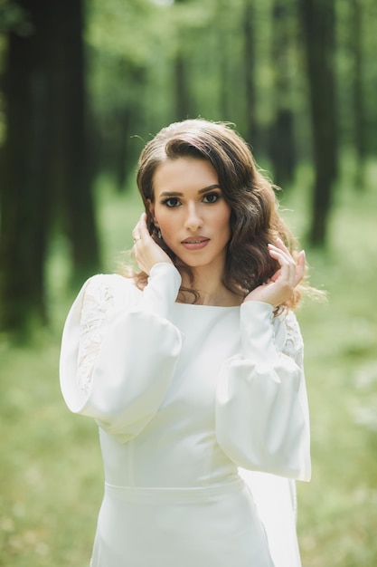 Beautiful bride in fashion wedding dress on natural background.