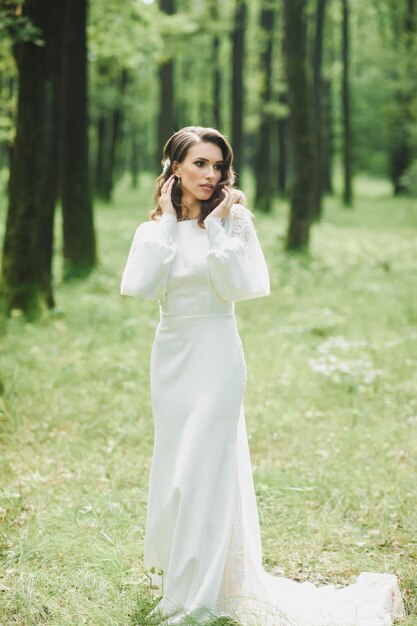 Beautiful bride in fashion wedding dress on natural background.