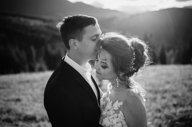 Beautiful bride and groom at the mountains