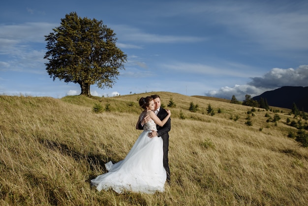 Beautiful bride and groom at the mountains