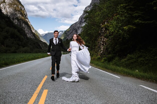 Beautiful bride and groom on the road