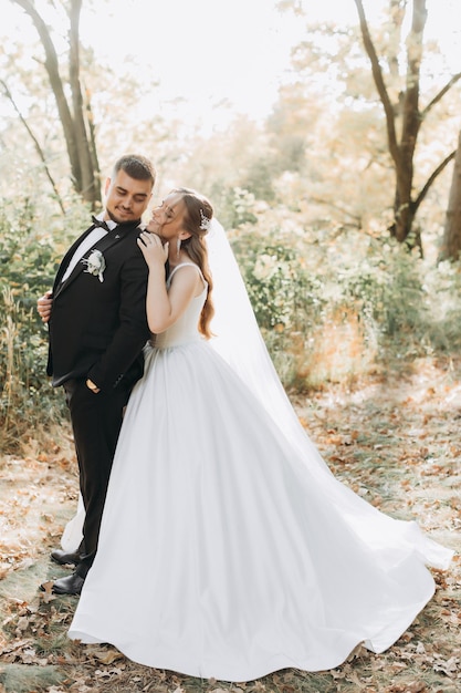 Beautiful bride and groom at sunset in green nature.