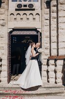 beautiful bride kissing with stylish groom standing at church after wedding matrimony gorgeous wedding couple after wedding holy ceremony newlyweds