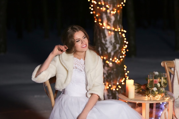 Beautiful bride outdoors on winter evening