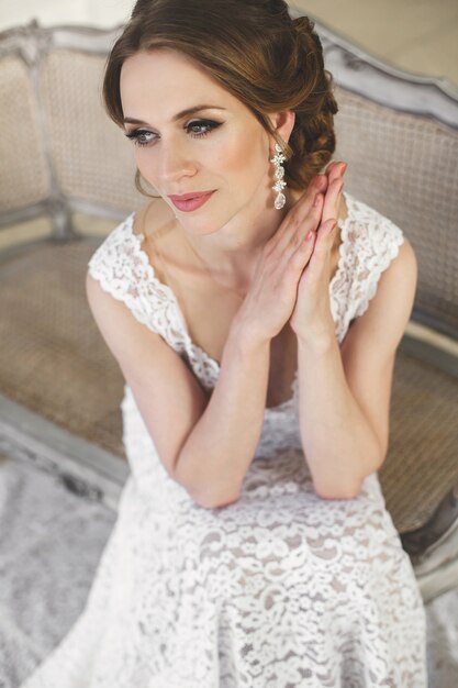 Beautiful bride posing in wedding dress in a white photo Studio