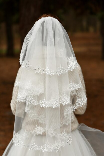 Beautiful bride standing back on a forest background