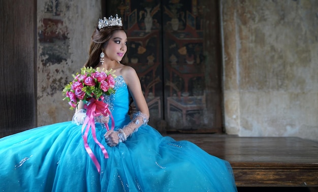 Foto bella sposa che indossa un vestito da sposa blu mentre tiene un bouquet