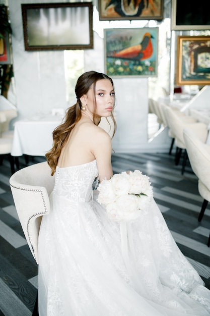 Beautiful bride wearing a fashion wedding dress in a beautiful restaurant