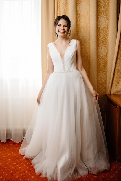 Beautiful bride in a wedding dress in the interior of the hotel