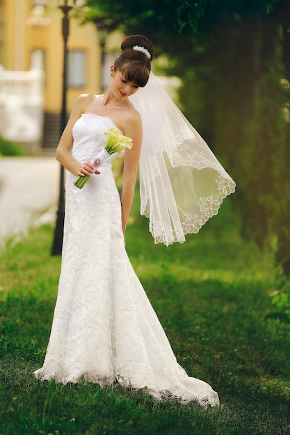 Beautiful bride in the wedding dress in nature