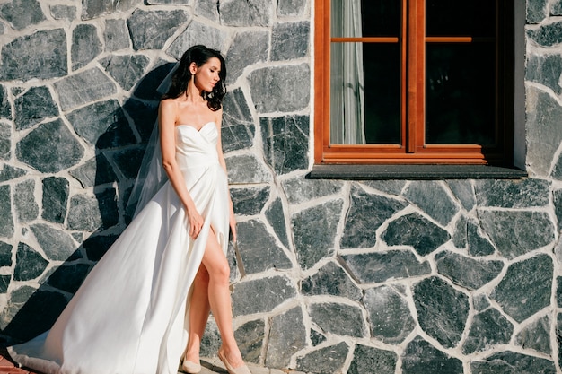 Beautiful bride in wedding dress posing outdoor
