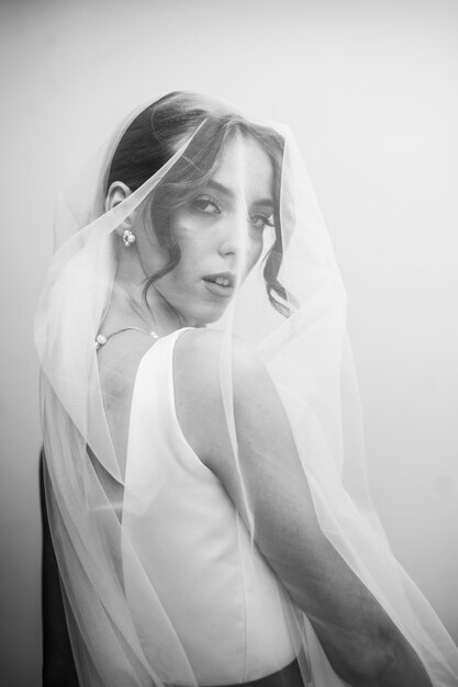 beautiful bride in a wedding dress and veil black and white