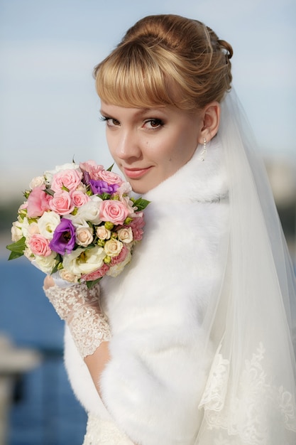 Beautiful bride in white fur coat