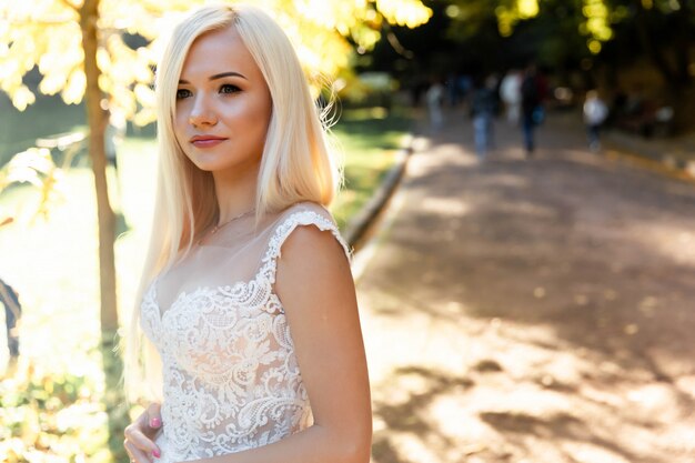 Beautiful bride with wedding makeup posing in wedding dress