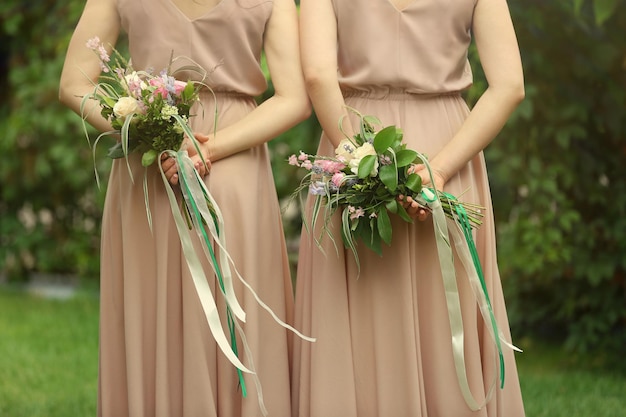 Beautiful bridesmaids holding bouquets