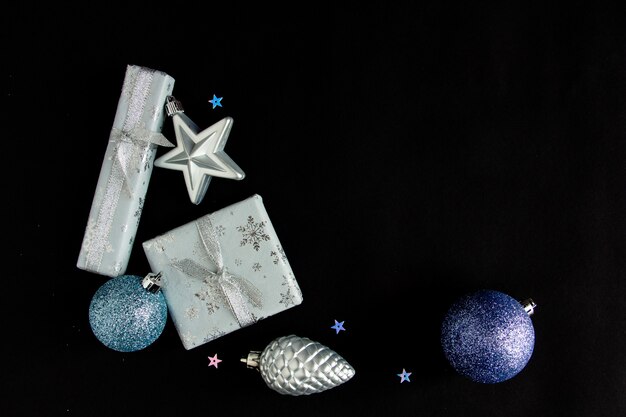 Beautiful bright christmas composition of new years toys on a black background postcardflat lay copy...