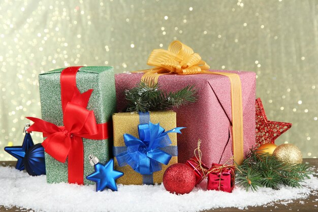 Beautiful bright gifts and christmas decor, on shiny background