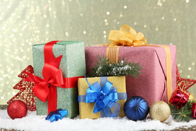 Beautiful bright gifts and christmas decor, on shiny background