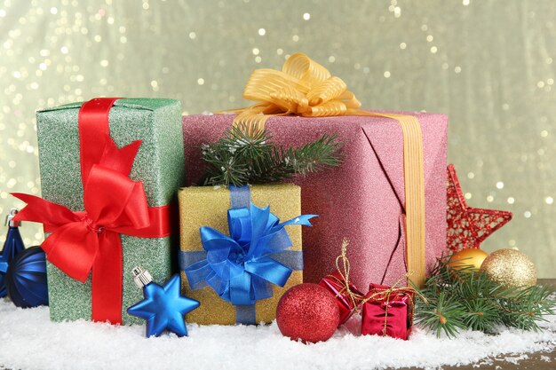 Beautiful bright gifts and christmas decor, on shiny background