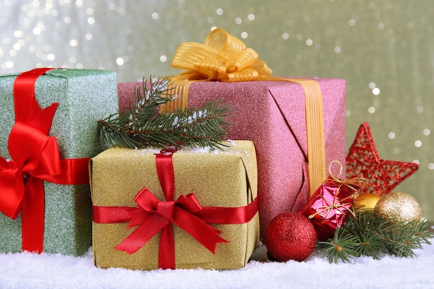 Beautiful bright gifts and christmas decor, on shiny background