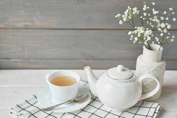 White Tea Pot And Cup With Tea Strainer On Wooden Table, Relaxing With Hot  Tea During Tea Break. Stock Photo, Picture and Royalty Free Image. Image  84607717.