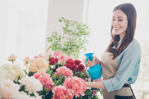 beautiful brunette botanist posing in her flower shop