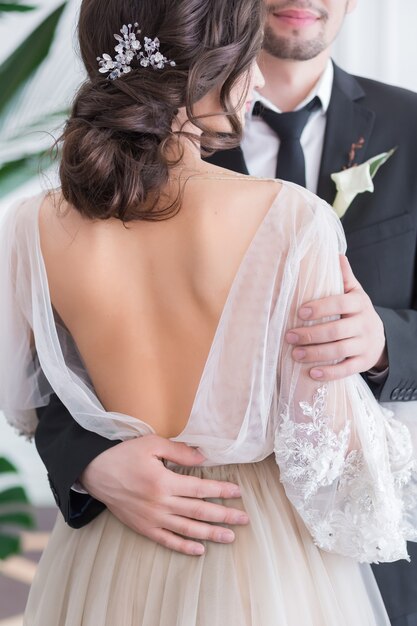 Beautiful brunette bride and groom portrait back view