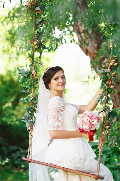 Beautiful brunette bride posing in a park