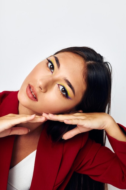 Beautiful brunette bright makeup red jacket posing studio model unaltered