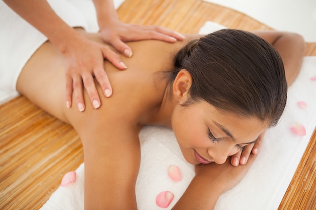 Beautiful brunette enjoying a back massage 