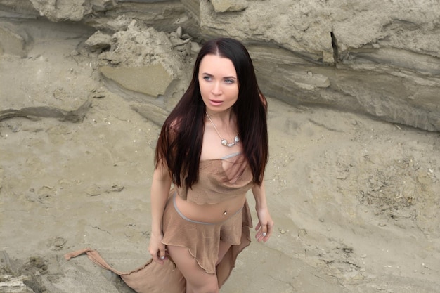 Beautiful brunette girl in an amazon costume in the desert