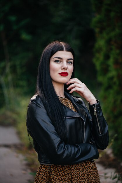 Beautiful brunette girl in a leather jacket.