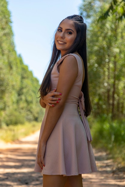 Beautiful brunette girl posing on photos in nature.