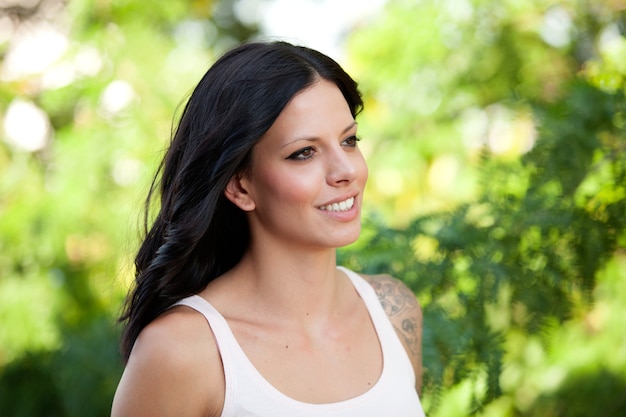 Beautiful brunette girl relaxing in the park 