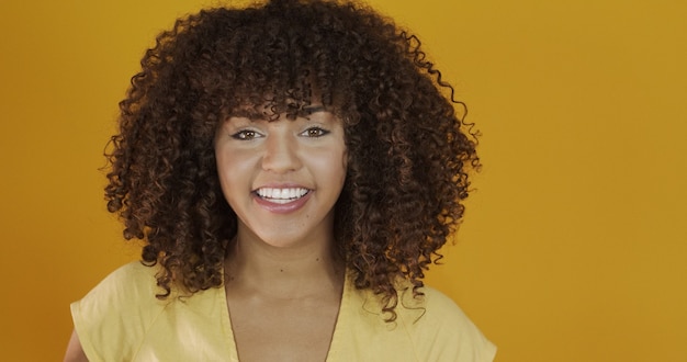 Beautiful brunette model smiling at camera. Beautiful teeth. Curly hair. Brazilian young woman.