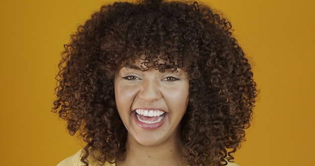 Beautiful brunette model smiling at camera. Beautiful teeth. Curly hair. Brazilian young woman.