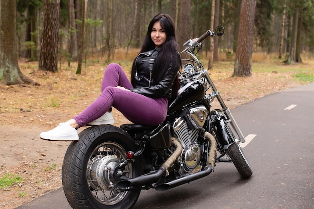 The beautiful brunette on a motorcycle