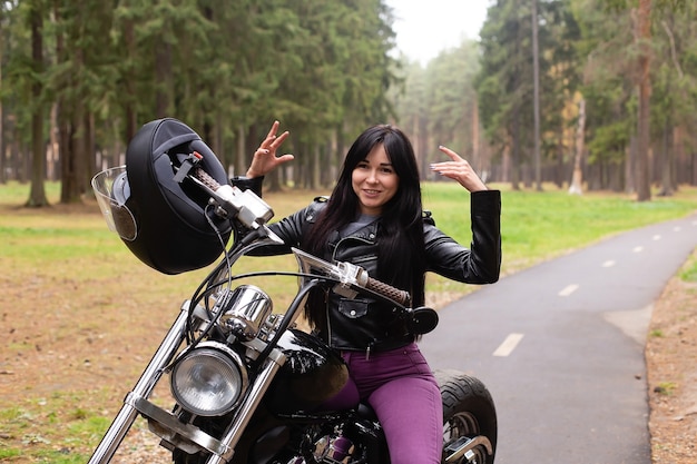 The beautiful brunette on a motorcycle